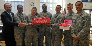 Members of the Mountain View-based California Air National Guard 129th Rescue Wing with Senator Jerry Hill receive 400 valentines made by South San Francisco seniors for Wing members who were recently deployed to Afghanistan and the Horn of Africa. From left, Hill, Captain Jennifer-Ruth Green, Staff Sergeant Jerald See, Airman First Class Tajudeen Mackey-Shittu, Airman First Class Joseph Harris, Airman First Class Raymond Perdue and Senior Airman Jet Crisostomo.