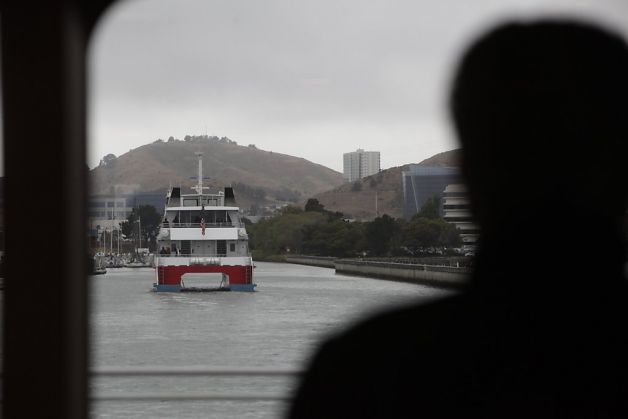 A passenger aboard the ferry Gemini watches the ferry Pisces (left) head back to the Oyster Point Marine Ferry Terminal after a bay cruise during the San Francisco Bay Ferry South San Francisco Inaugural Celebration. Photo: Lea Suzuki, The Chronicle 