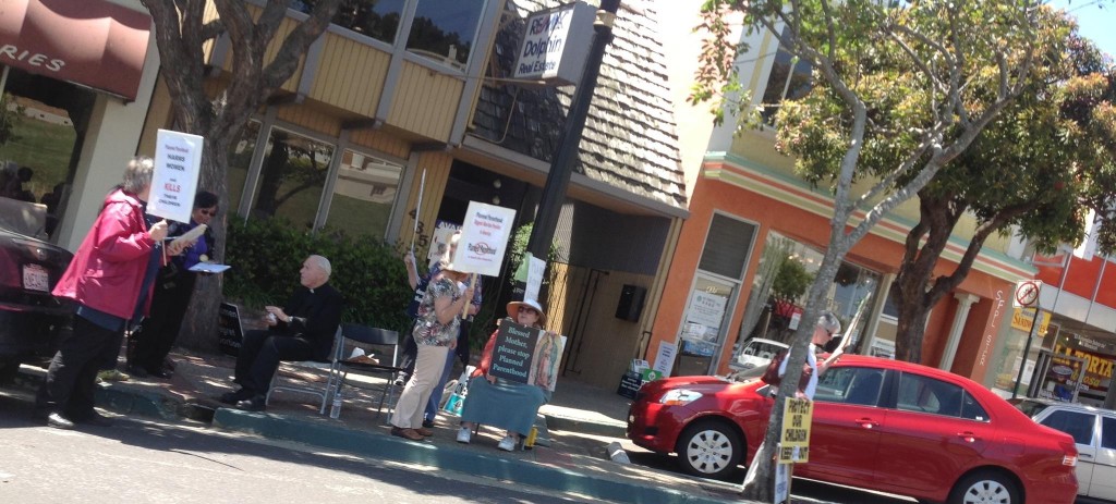 A small group of protesters were out in front of local businesses on the 400 block of Grand Avenue 