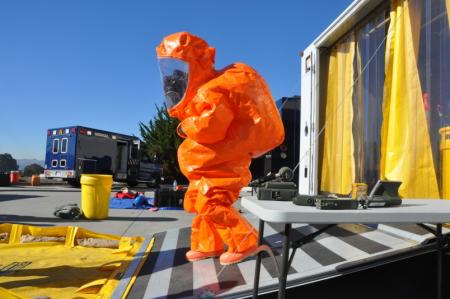 The 95th Civil Support Team decontamination specialist Staff Sgt. Leslie Greenfield emerges from a decontamination trailer wearing a Level A Hazmat suit after decontaminating entry teams during Operation Pure Cure on Jan. 22, 2014, in South San Francisco Photo: Capt Jason Sweeney 
