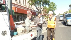 Frank McAuley discusses the benefits of the new inductance lamps with city intern Steven Shyun and Chris from Phoenix Electric Company Photo: ESC