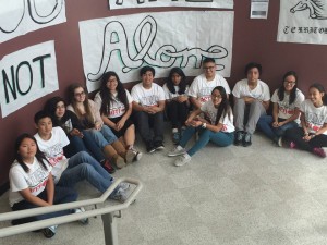 #5. SIA members posing underneath their You are Not Alone sign for AntiBullying Week