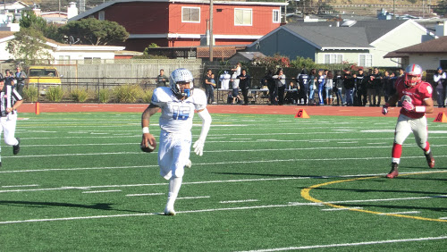 South City quarterback Kolson Pua rolls out on a six-yard run in the second quarter of the Bell Game, on Saturday, Nov. 14, 2015.  Photo by John Baker.