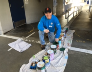 Dr Skerry serving our community at Los Cerritos Elementary School, painting messages for our students.