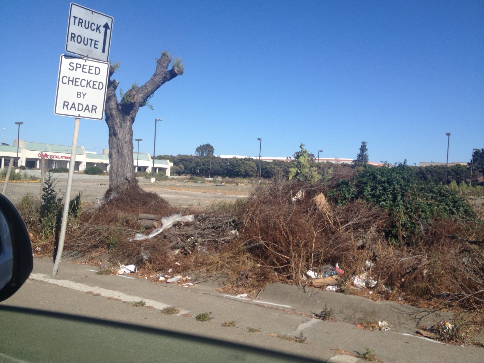 The blight at the corner of El Camino Real/Spruce needs to be resolved