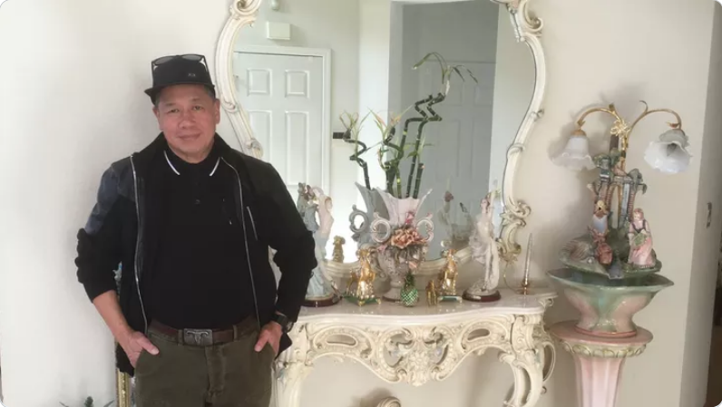 Nemesio Isorena: a man in a black shirt and jacket posing in front of a white mirror